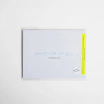 White greeting card with “Thinking of You” embossed in light blue Braille.
