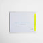 White greeting card with “Thinking of You” embossed in light blue Braille.