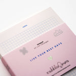 Modern pink notepad with graphic blue grid and notes heading – 100-page stationery. (front view 3)