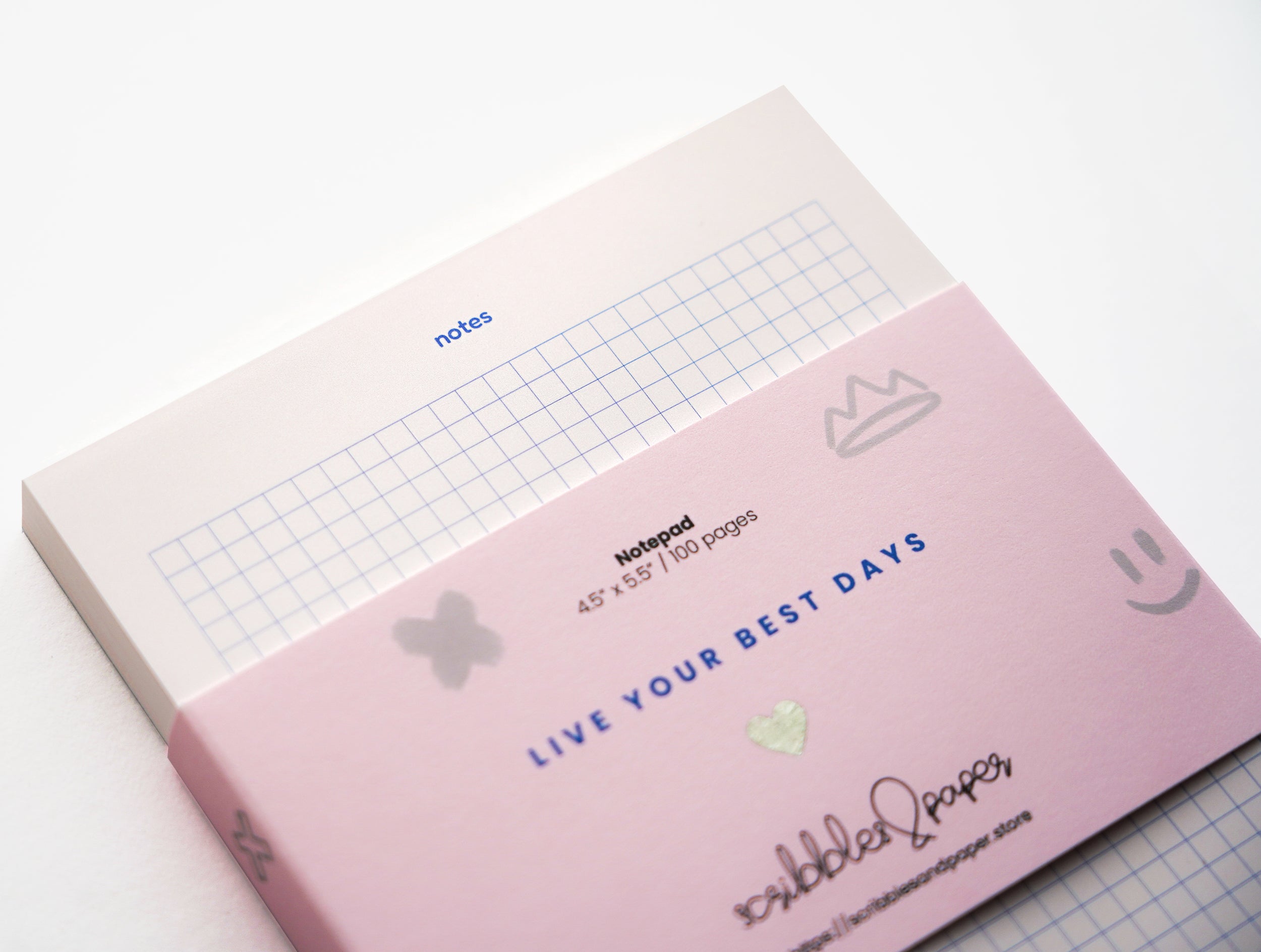 Modern pink notepad with graphic blue grid and notes heading – 100-page stationery. (front view 3)