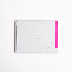 White greeting card with “Thank You” embossed in light pink Braille.